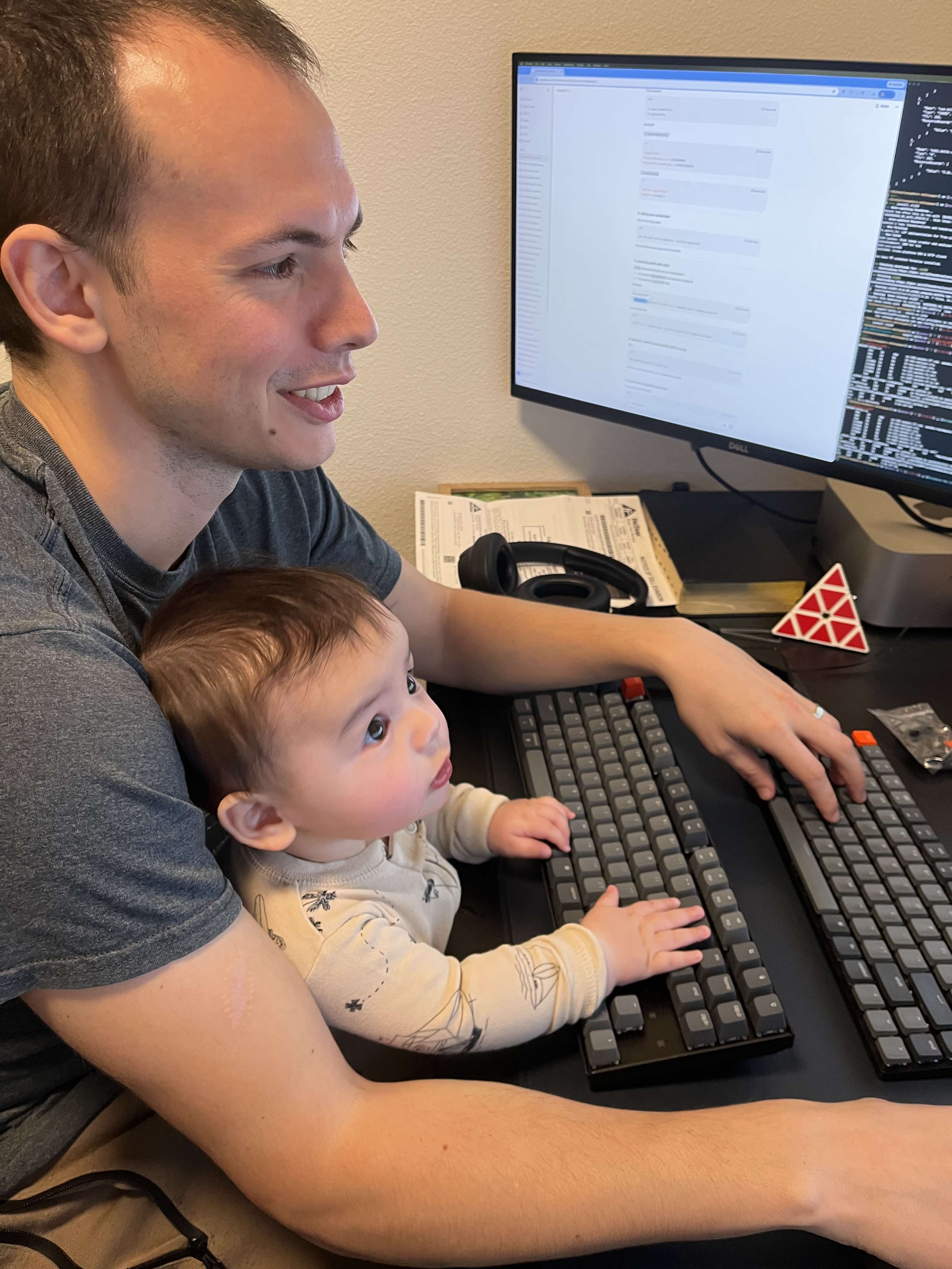 Alan using the computer with dad. We got him a training keyboard, because otherwise he gets too interested in the flashing lights on my keyboard and starts mashing buttons.